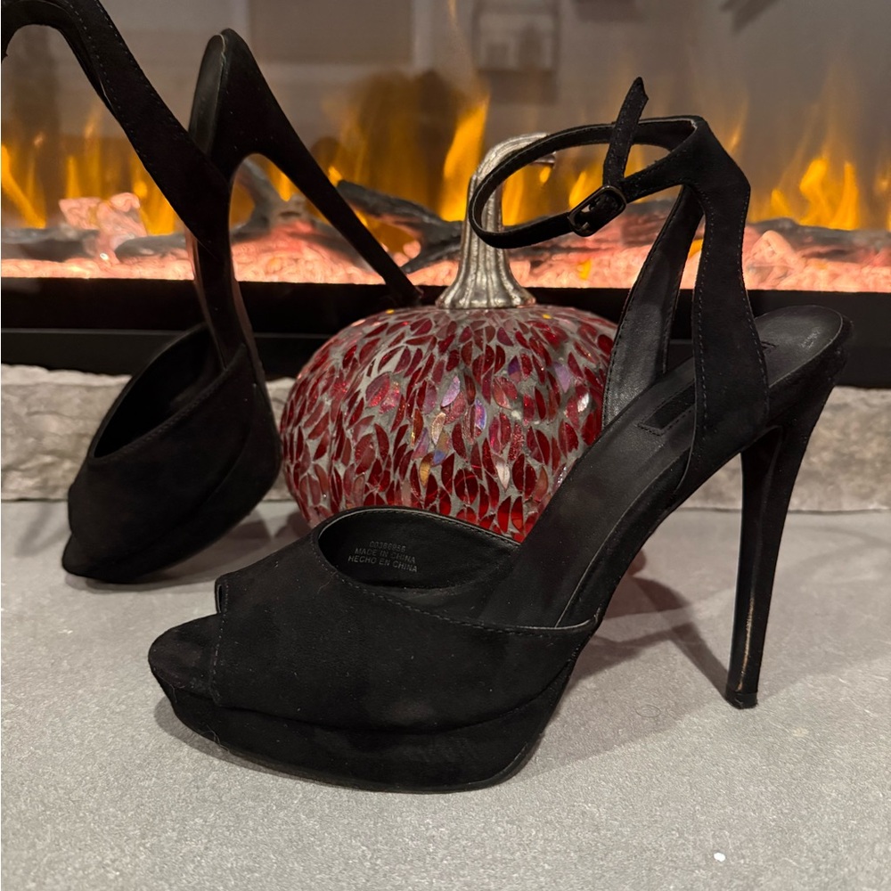 Black suede peep toe platforms with ankle straps.